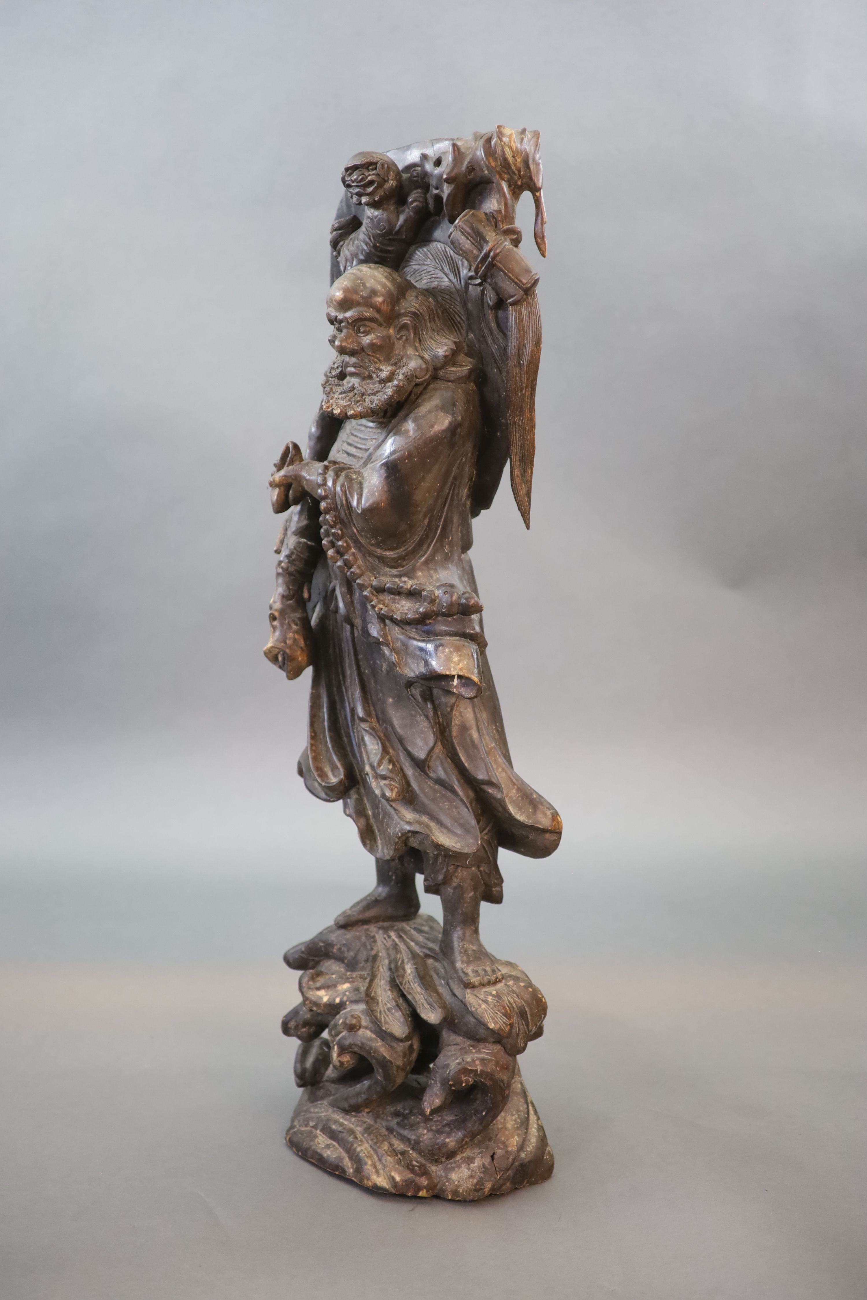 An early 20th Chinese carved hardwood figure of a Luohan